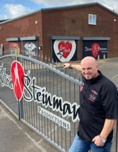 Steve Steinman outside of our HQ after the shutters have been updated with the production artwork.